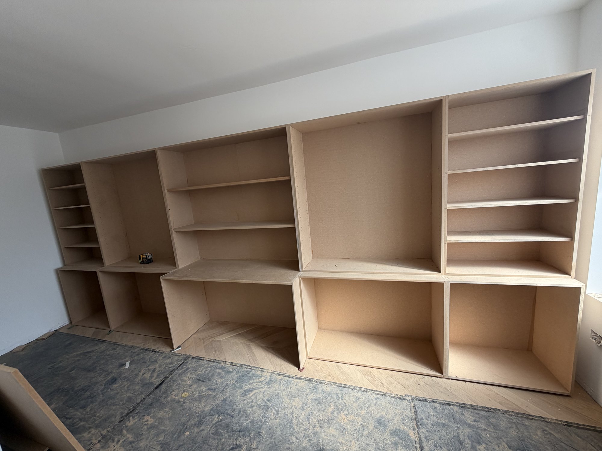 Fitted wardrobes with oak slat media wall